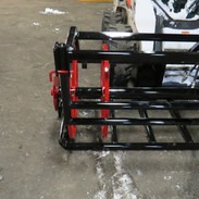 A shining vibrant red metal wheel with black spokes in front view