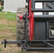 A skid steer attachment with a big wheel behind it