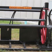 A skid steer attachments for skid steer loader with a orange sign on top